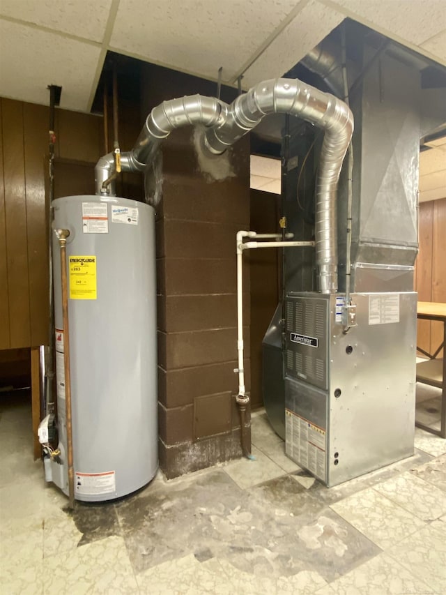 utility room featuring gas water heater and heating unit