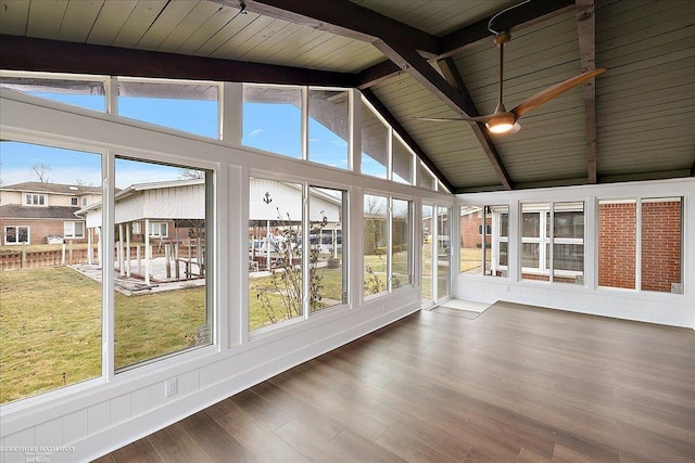 unfurnished sunroom with lofted ceiling with beams, wood finished floors, and wood ceiling