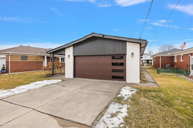 view of front of home with concrete driveway, an attached garage, brick siding, and a front yard