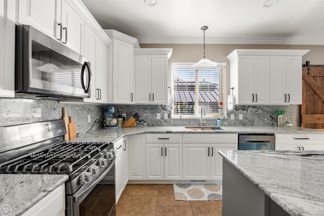 kitchen with stainless steel appliances, a sink, tasteful backsplash, white cabinetry, and crown molding
