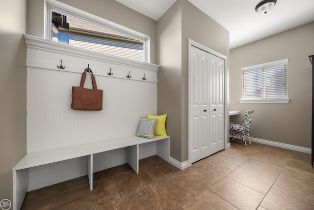 mudroom with baseboards and tile patterned flooring