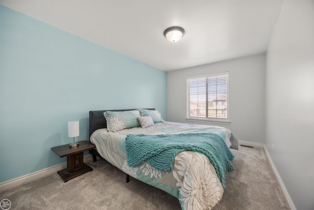bedroom featuring carpet and baseboards