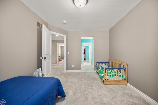 bedroom featuring visible vents, baseboards, and carpet