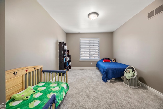 carpeted bedroom with visible vents and baseboards