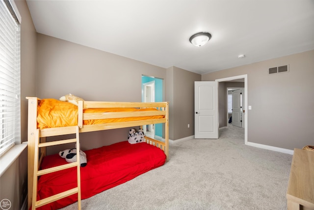 bedroom featuring baseboards, visible vents, and carpet