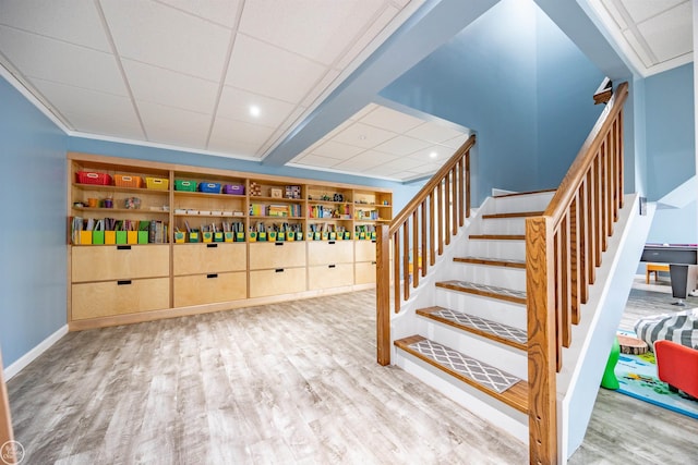 interior space with recessed lighting, wood finished floors, a drop ceiling, and baseboards