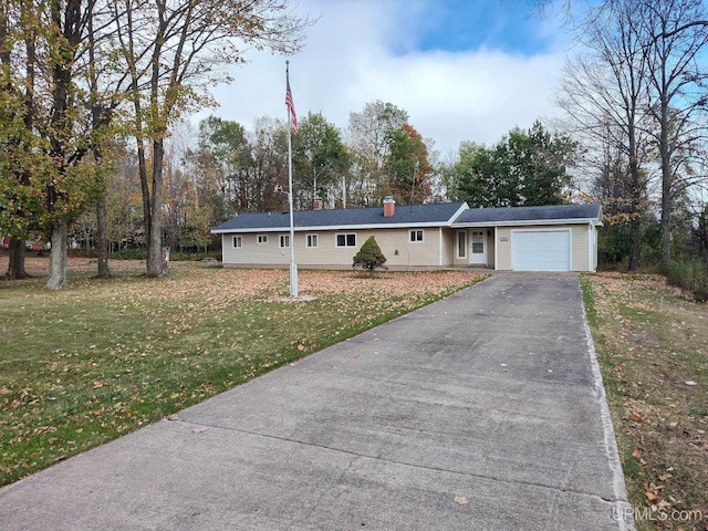 ranch-style home featuring a chimney, an attached garage, aphalt driveway, and a front yard