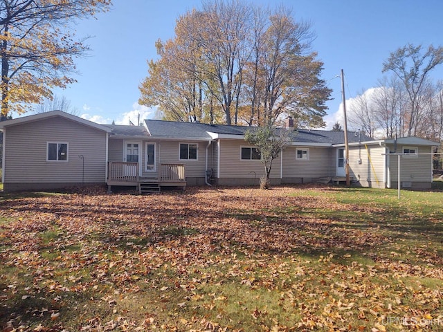 rear view of house featuring a chimney and a deck
