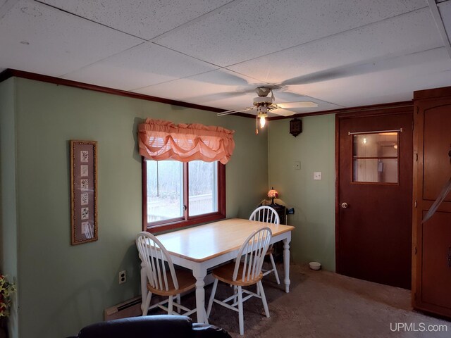 carpeted dining room with baseboard heating and ceiling fan