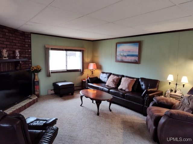 carpeted living area featuring a baseboard radiator and a drop ceiling