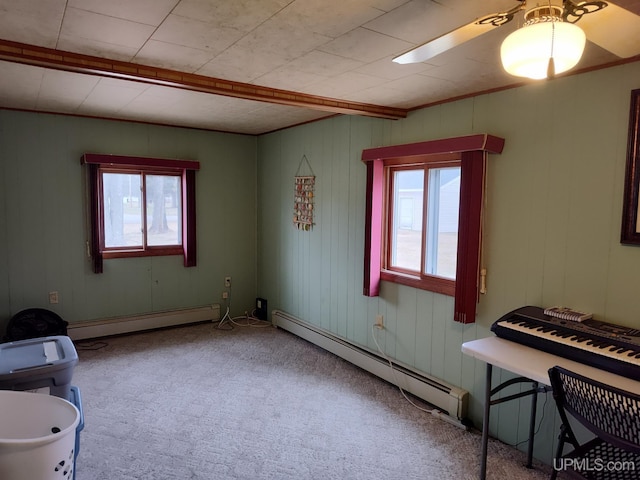 interior space featuring a baseboard heating unit, carpet floors, and plenty of natural light