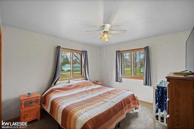 carpeted bedroom featuring a ceiling fan and baseboards