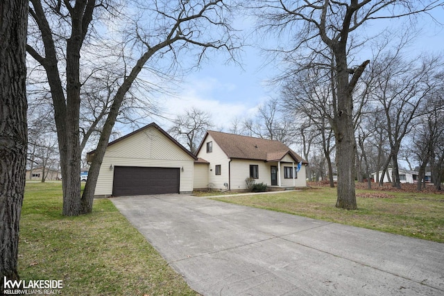 ranch-style house with an attached garage, driveway, and a front yard