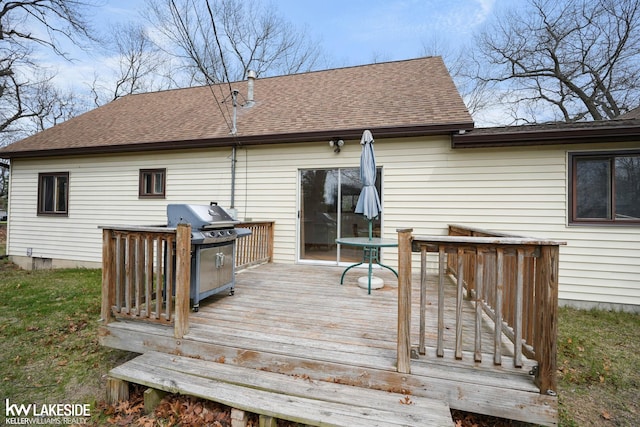 wooden deck featuring a grill