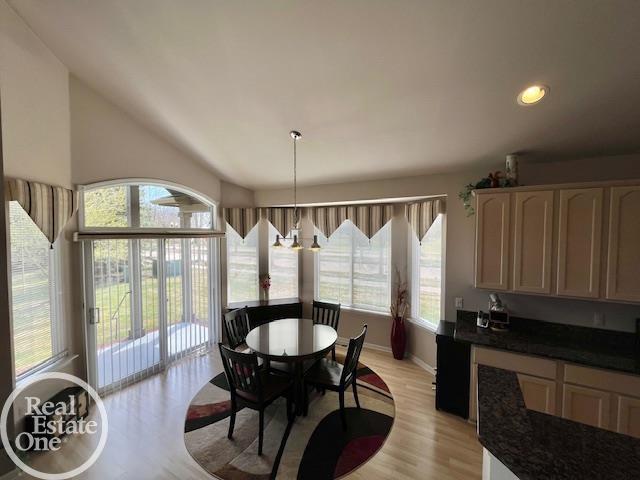 dining area featuring recessed lighting, baseboards, light wood finished floors, and plenty of natural light