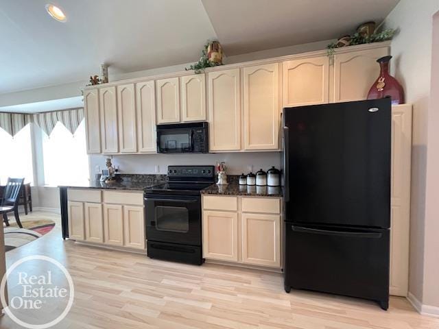kitchen with light wood finished floors, baseboards, cream cabinets, and black appliances