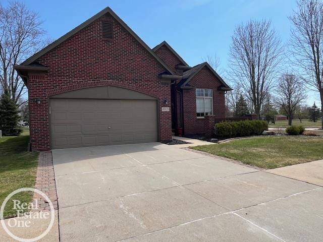 traditional home with a front lawn, brick siding, and concrete driveway