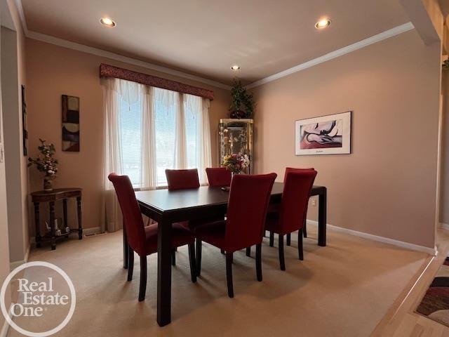 dining area with light carpet, baseboards, recessed lighting, and ornamental molding