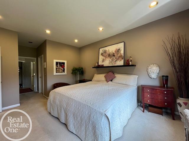 bedroom featuring recessed lighting, baseboards, and light colored carpet