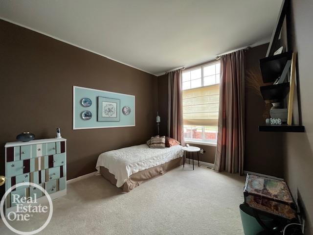 carpeted bedroom featuring baseboards