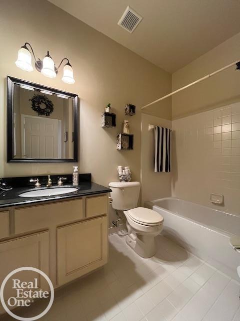 full bath featuring tile patterned floors, bathing tub / shower combination, visible vents, toilet, and vanity