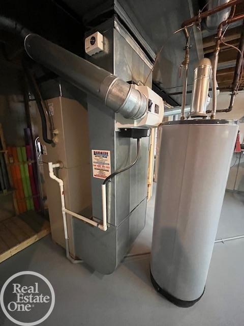 utility room featuring water heater
