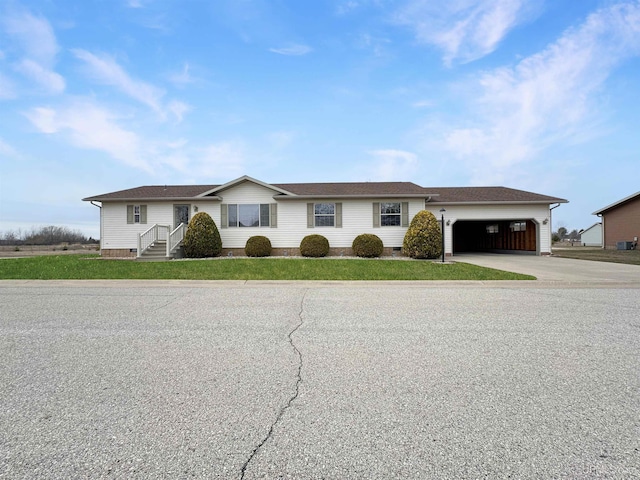 single story home with a garage, driveway, crawl space, and roof with shingles