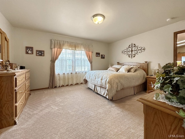 bedroom featuring light colored carpet