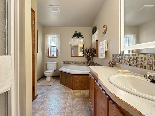 full bath with a bath, visible vents, vanity, and toilet
