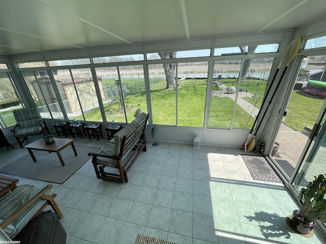 sunroom / solarium featuring a water view