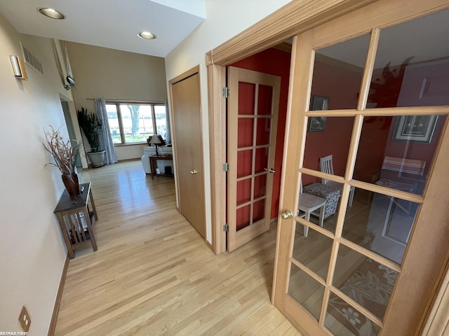 hall featuring visible vents, french doors, wood finished floors, and recessed lighting
