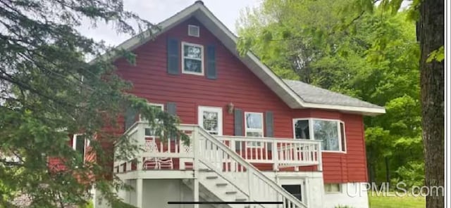 back of house with a wooden deck and stairs
