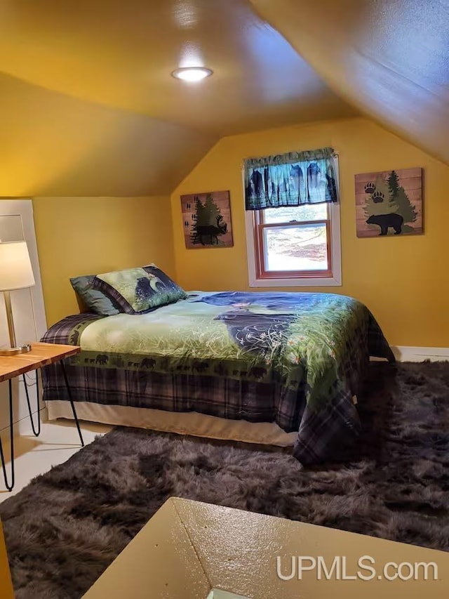 bedroom with lofted ceiling
