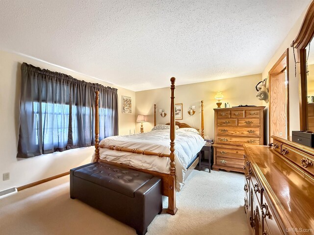 2709 W 6th Ave, Gladstone, MI 49837 - carpeted bedroom featuring a textured ceiling and visible vents