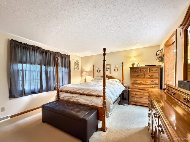 2709 W 6th Ave, Gladstone, MI 49837 - bedroom featuring carpet floors, a textured ceiling, visible vents, and baseboards