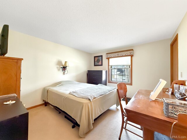 2709 W 6th Ave, Gladstone, MI 49837 - bedroom featuring light carpet and baseboards
