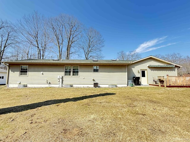 2709 W 6th Ave, Gladstone, MI 49837 - rear view of house featuring a yard and a deck