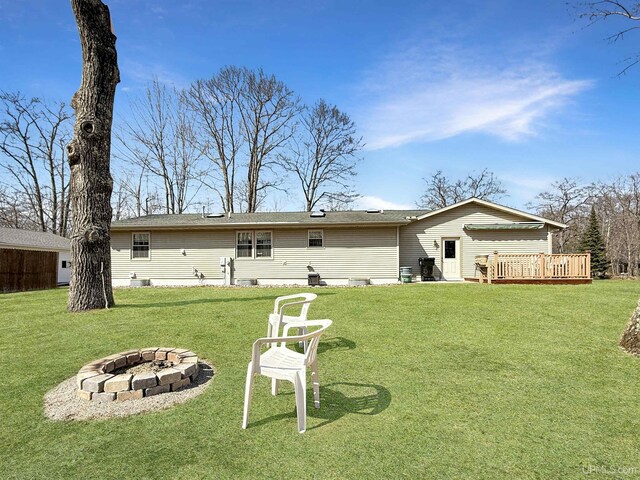 2709 W 6th Ave, Gladstone, MI 49837 - rear view of house featuring a fire pit, a yard, and a deck