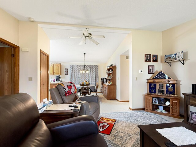 2709 W 6th Ave, Gladstone, MI 49837 - living room featuring lofted ceiling, visible vents, light carpet, baseboards, and ceiling fan with notable chandelier