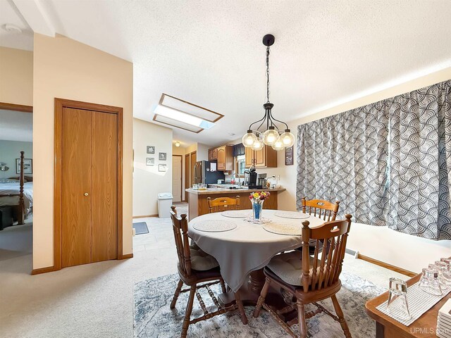 2709 W 6th Ave, Gladstone, MI 49837 - dining room with a textured ceiling, a skylight, and light carpet