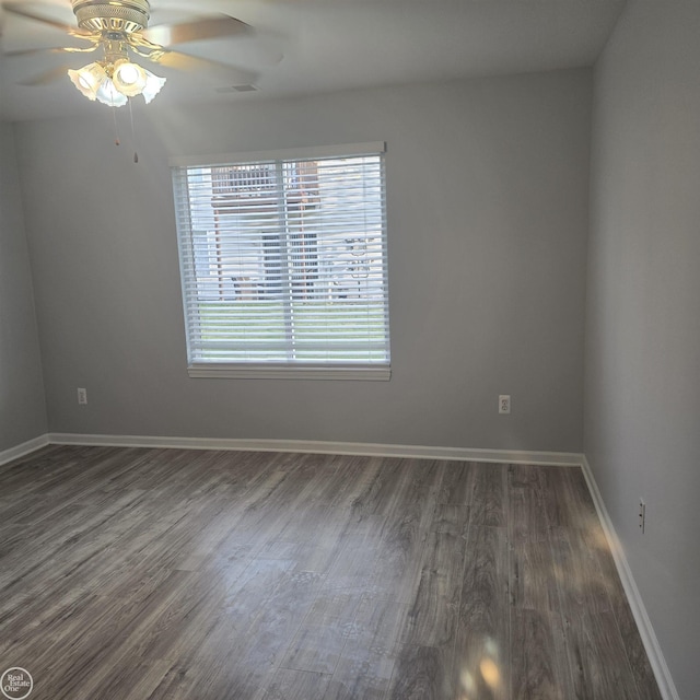 30288 Wedgewood Cir, Roseville, MI 48066 - empty room with dark wood-type flooring, a ceiling fan, and baseboards