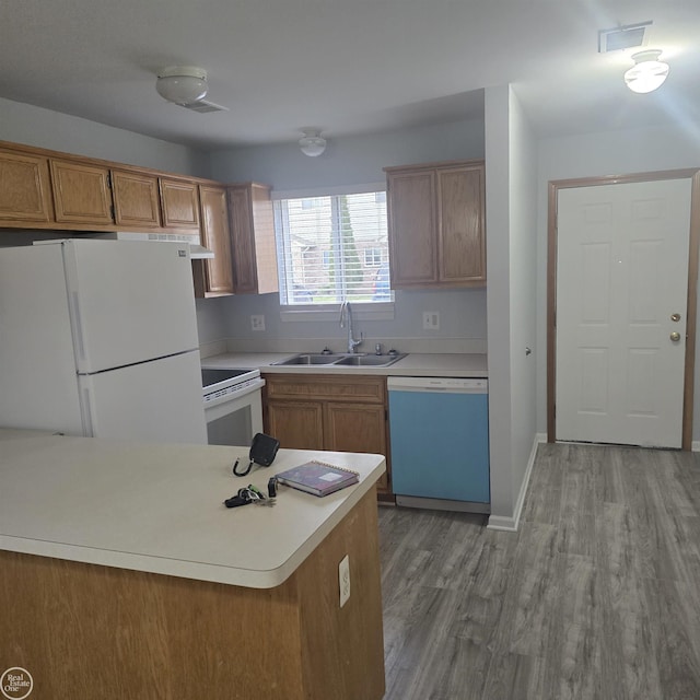 30288 Wedgewood Cir, Roseville, MI 48066 - kitchen featuring light wood finished floors, a sink, white appliances, and light countertops