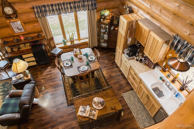 living room with log walls and dark wood-type flooring