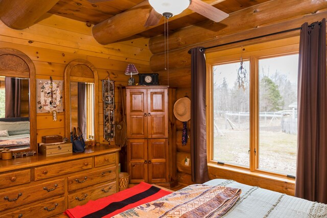 bedroom featuring beamed ceiling, wood walls, and wood ceiling