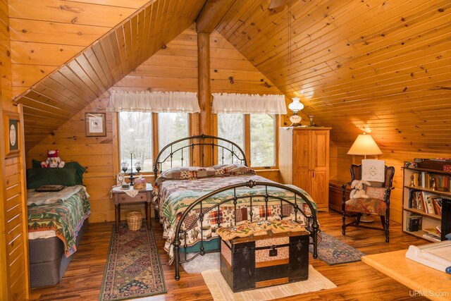 bedroom with wood ceiling, wood finished floors, vaulted ceiling with beams, and wooden walls