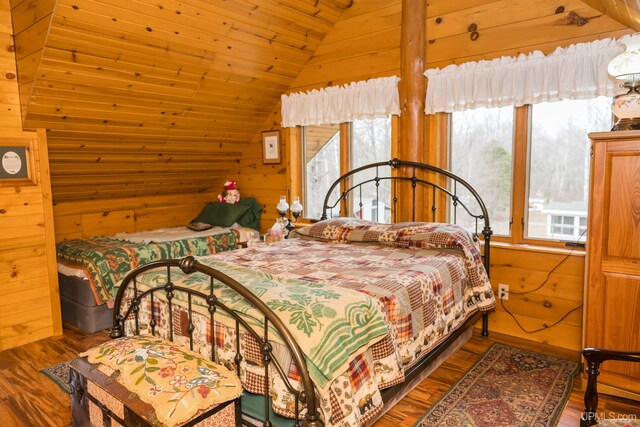 bedroom with wooden walls, lofted ceiling, wood ceiling, and wood finished floors