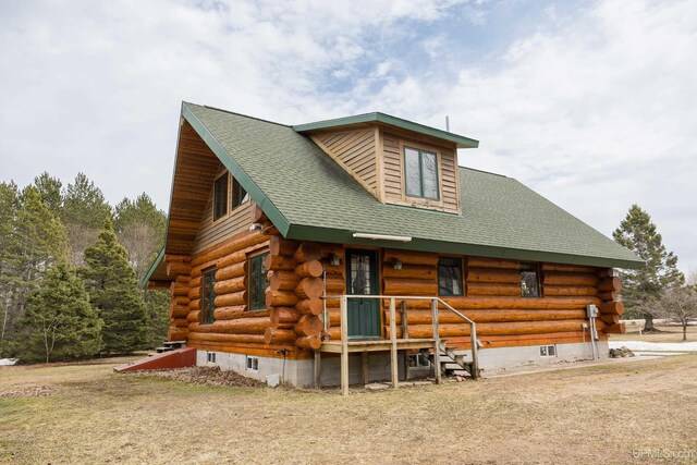 view of front of property featuring log exterior and roof with shingles