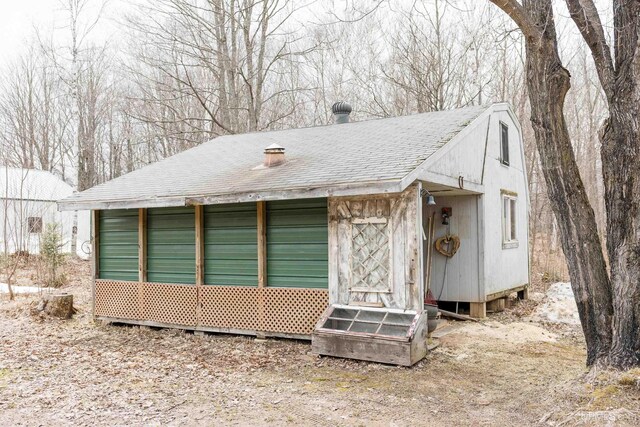 view of home's exterior featuring a shingled roof and entry steps