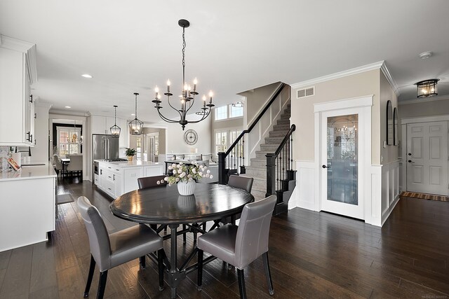 dining space featuring a notable chandelier, visible vents, ornamental molding, and a healthy amount of sunlight