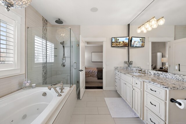 ensuite bathroom featuring a shower stall, a tub with jets, ensuite bathroom, vanity, and tile patterned flooring